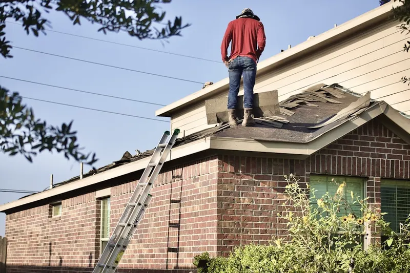 Professional roofer working on a residential roof in Shadeland